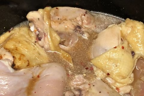 Carolina pulled chicken in slow cooker with spices and sauce