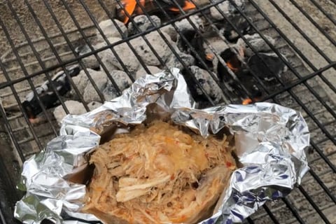 Carolina pulled chicken in foil on Charcoal grill with wood