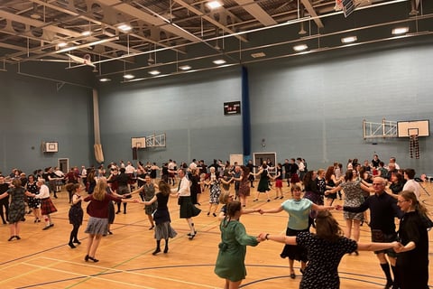 Dancers in a gymnasium, dancing circles