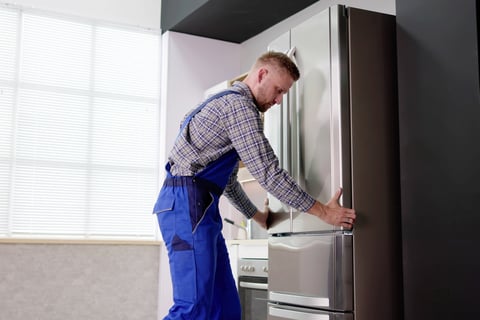 a man installing the refrigerator