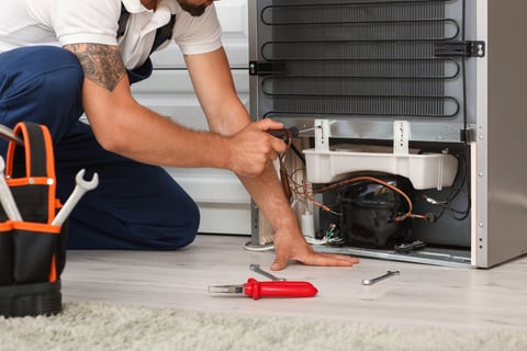 technician doing fridge service