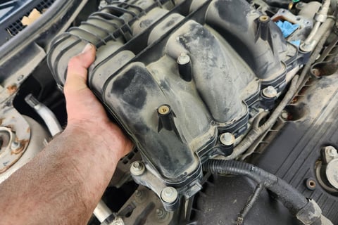 Fast T's Master Tech removing an intake manifold from a Honda accord to replace the intake gasket and spark plugs