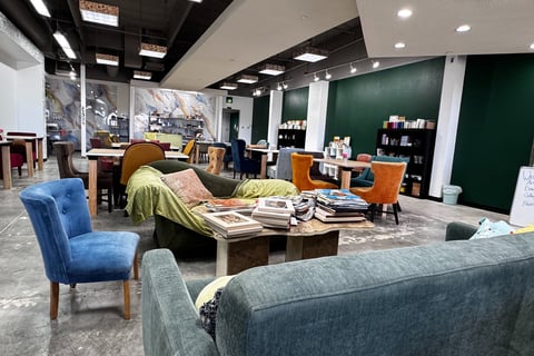 This is a photo of the interior of Clay Paper Ink. There is a variety of comfortable unique chairs. 