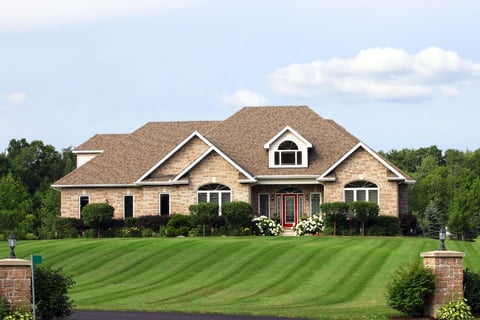 Large lot with tan bick home
