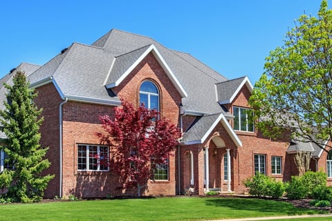 Grand brick home with beautiful landscaping