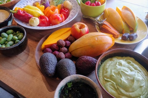 a table with bowls of fruit and vegetables
