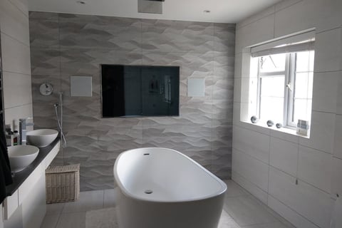 65" Auquavision, waterproof TV mounted onto a wall in a bathroom