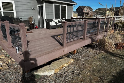 a deck with a bench and chairs