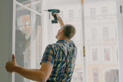 a handyman is holding a drill and a cordless cordless drillet