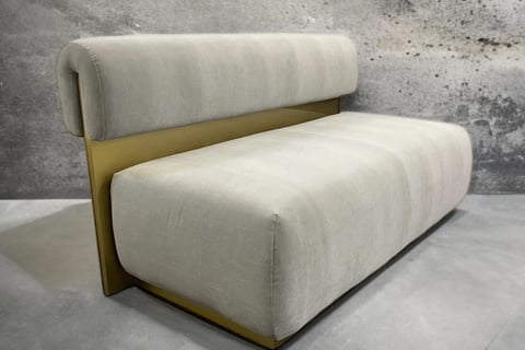 Modern bench with plush cream cushions and gold metal back, by Solo Home Decor.