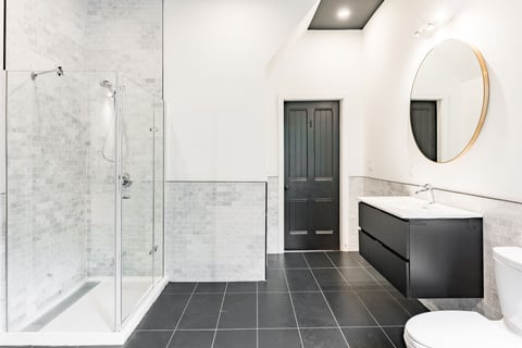 a large master bath with marble back-splash