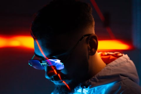 a man in a blue jacket and sunglasses