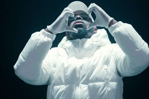 a man in a white jacket and sunglasses