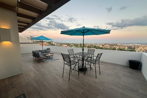 Casa Janet patio occean view with tables and umbrellas