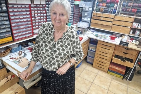 a woman standing in a craft shop