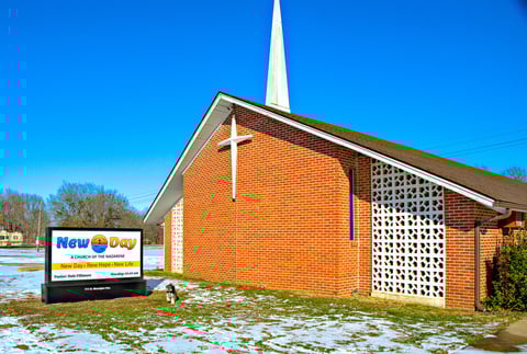 Our church with our new sign, photobombed by the Pastor's dog, Scamp.