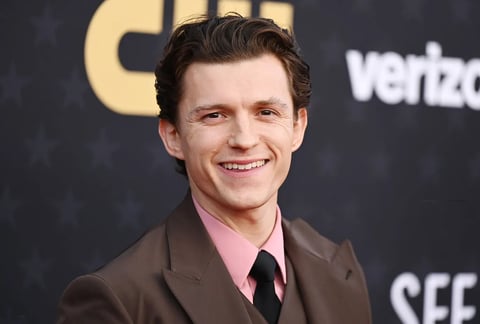 Tom Holland attending The Crowded Room premiere in a tailored tux