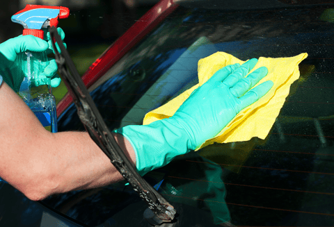 a person in gloves and gloves cleaning a car