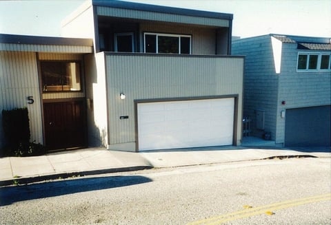 Double wide garage door on a hill with bottom trailer.