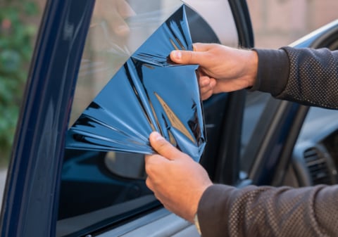 a person holding a piece of paper with a blue triangle