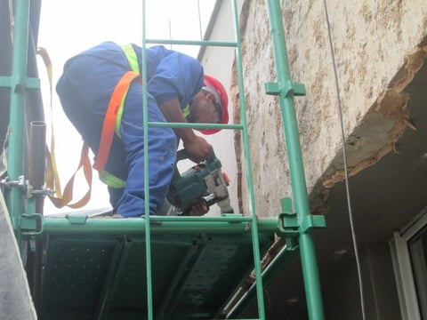 Mechanical stripping of compromised exterior plaster for waterproofing works, Sandhurst Towers, Sandton