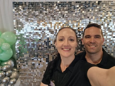 SweetAz Co. in front of the silver shimmer wall at Fiction Bar in Cleveland for Ash's 40th.