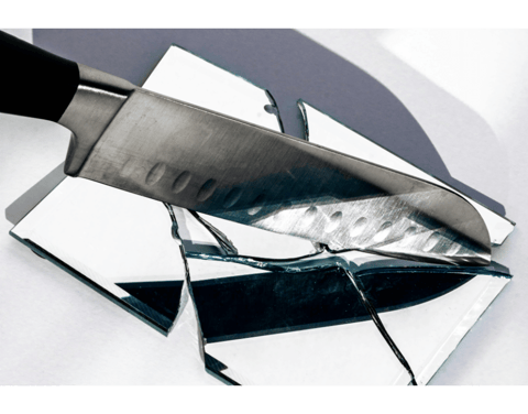 knife held over a broken mirror