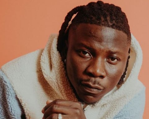 Stonebwoy in a brown sweater.