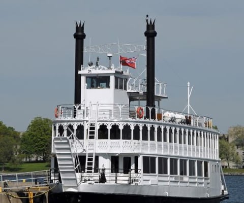 a large white boat with a flag on it