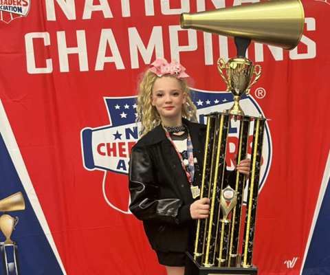 baylor holding an nca championship trophy