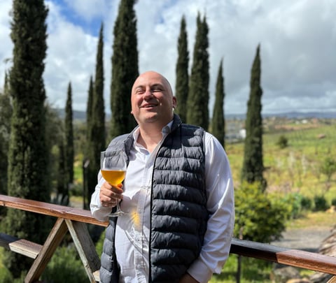 a man in a vest and vest with a beer glass