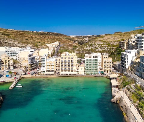 Aerial view of Xlendi Bay from high above the water. 