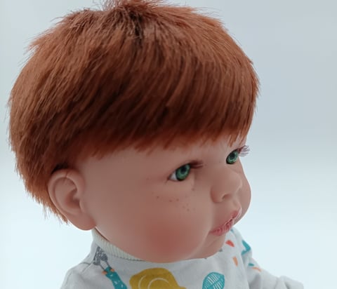 Boy doll with green eyes and red hair