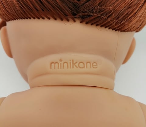 Minikane stamp on the back of a dolls neck