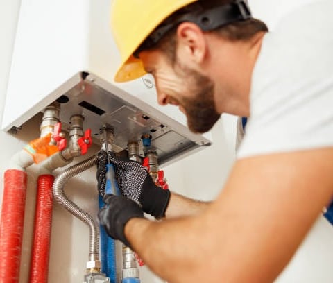 plumber installing a water heater 