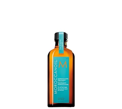 Moroccanoil Treatment Oil in amber bottle with turquoise label
