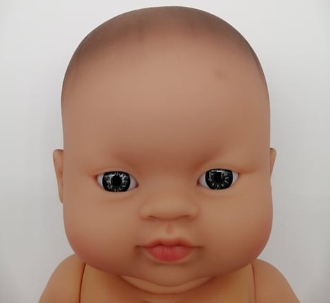 a Minikane baby doll with light coloured eyes