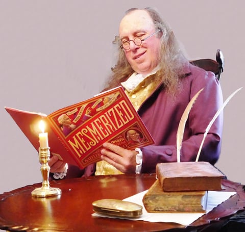 Actor costumed as Benjamin Franklin reading Mesmerized