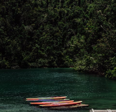 a boat is docked at a dock with a boat in the water