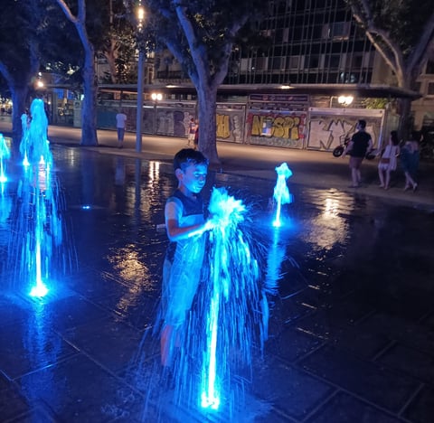 One summer night in Montpellier a young boy cools off