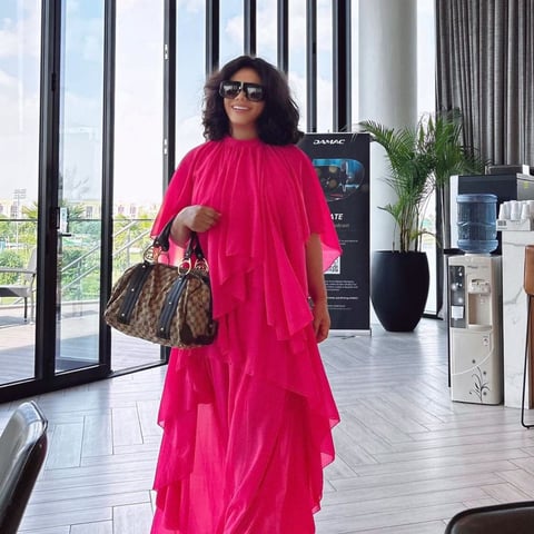 Nadia Buari in a bright pink dress.
