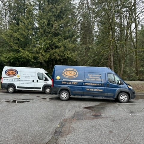 two renovation service vans parked in a parking lot