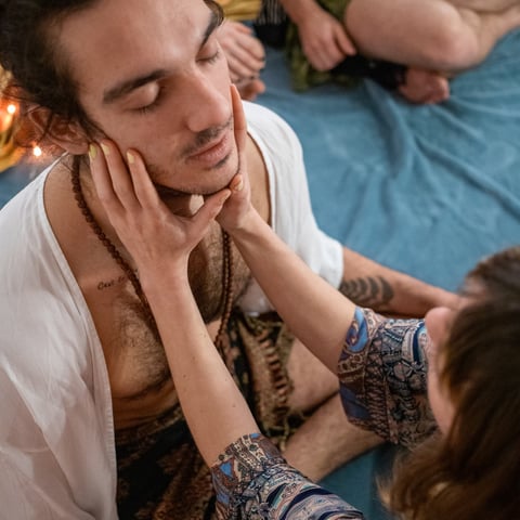 a man with a beard and a woman in a white shirt