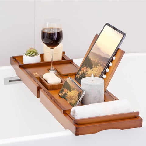 a tabletop with a tablet and a glass of wine