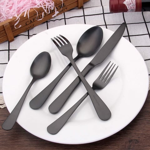a plate with spoons and forks on a table