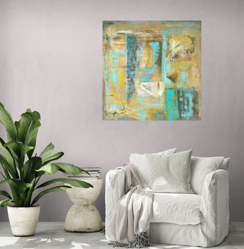 Wall art in ochre and turquoise in lounge chair setting with palm tree