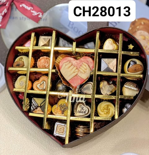 a heart shaped box with chocolates and candy