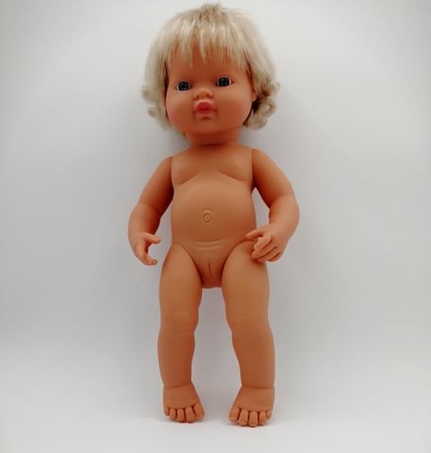 Miniland doll with blonde hair standing