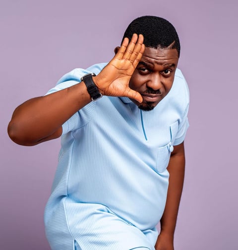 Nacee in a blue material shirt.