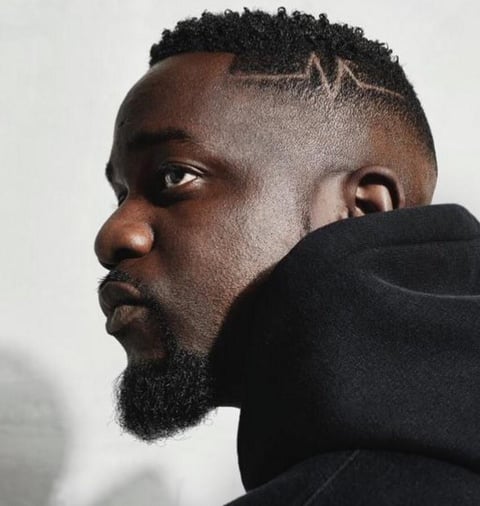 Sarkodie in a black sweater.